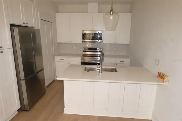 a kitchen with a refrigerator and a stove
