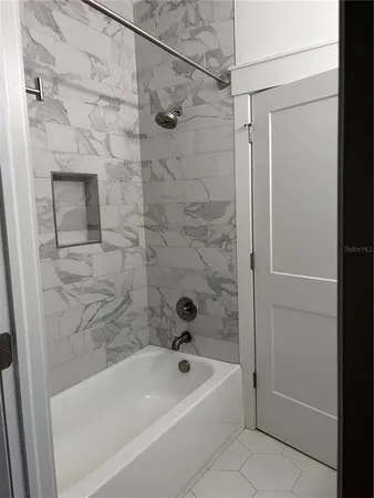 a bathroom with a bathtub and a shower