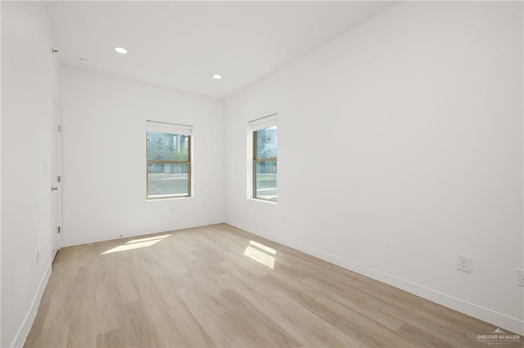 500 South Ware Road McAllen, TX 78501 - Photo 8 of 10 an empty room with wooden floor and windows