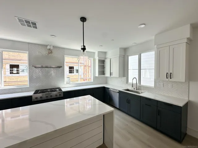 a kitchen with a sink stove and cabinets