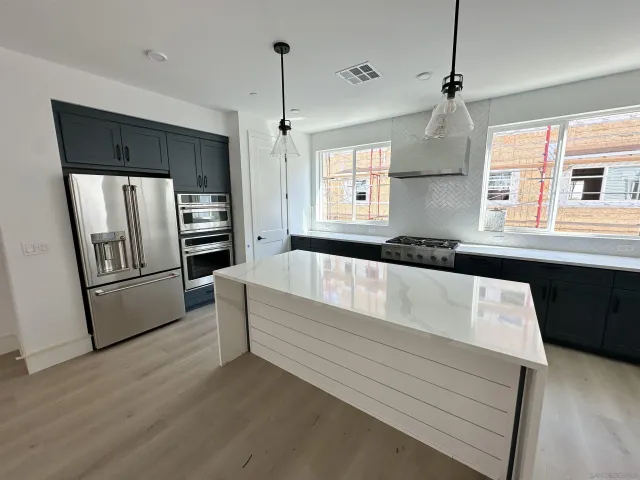 a kitchen with a refrigerator and a sink