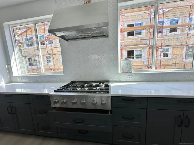 a kitchen with stainless steel appliances a stove and a sink