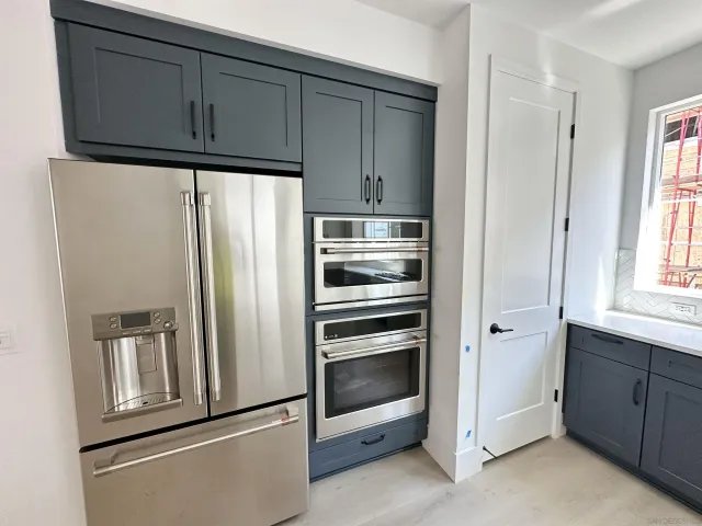 a kitchen with cabinets and stainless steel appliances