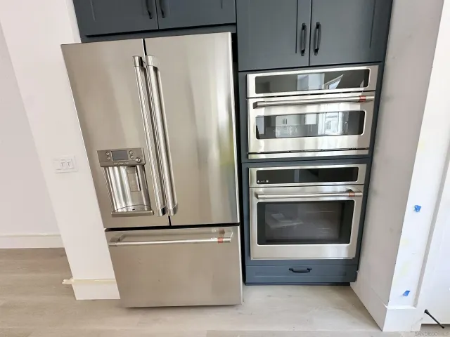 a kitchen with refrigerator and microwave