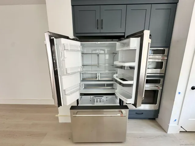a view of walk in closet with empty racks