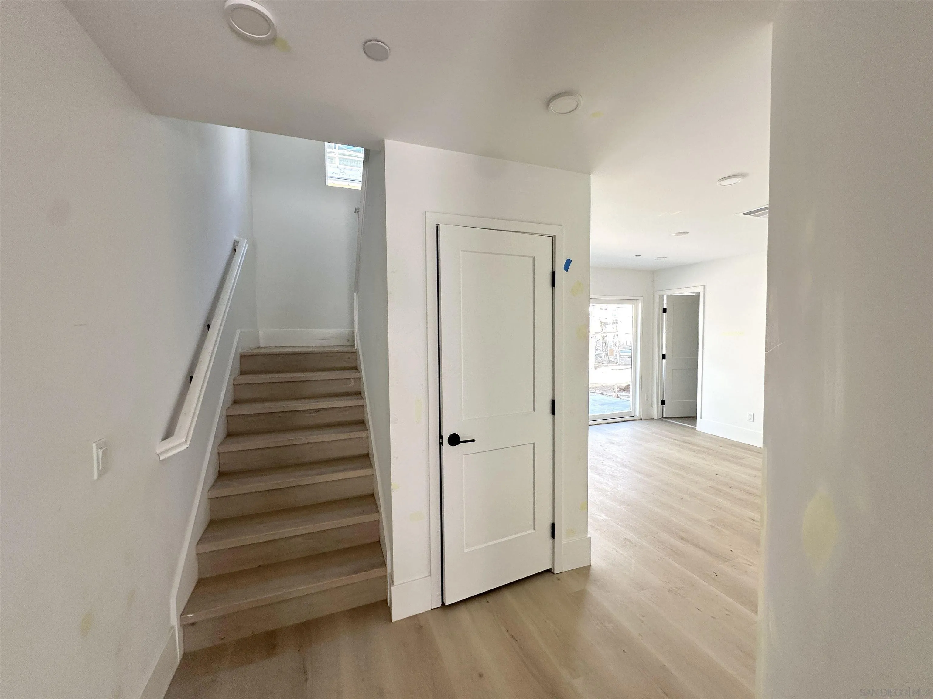 7290 Ponto Drive South, Unit 207 Carlsbad, CA 92011 - Photo 5 of 32 a view of a hallway with wooden floor and staircase