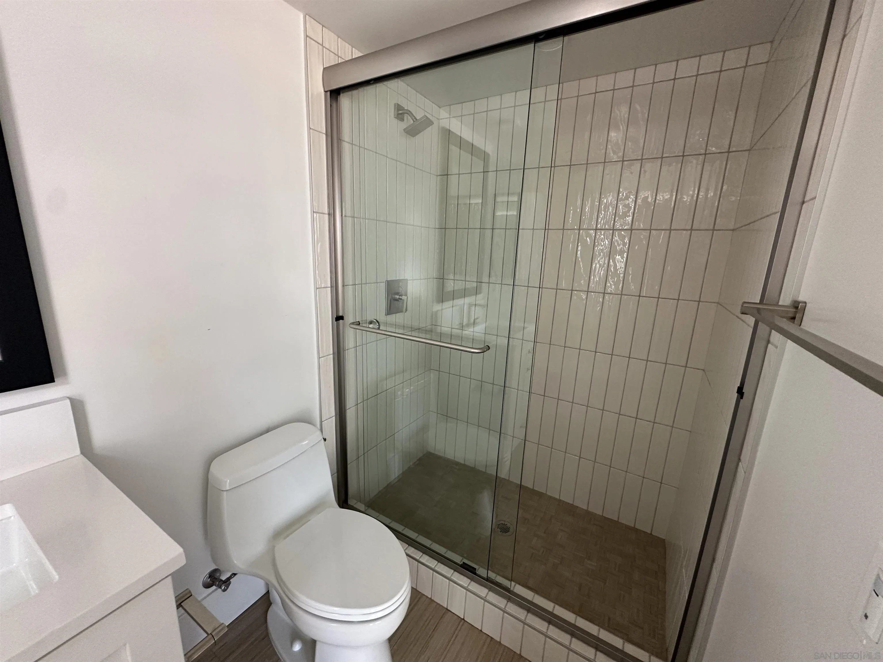 7290 Ponto Drive South, Unit 207 Carlsbad, CA 92011 - Photo 9 of 32 a bathroom with a shower and a toilet
