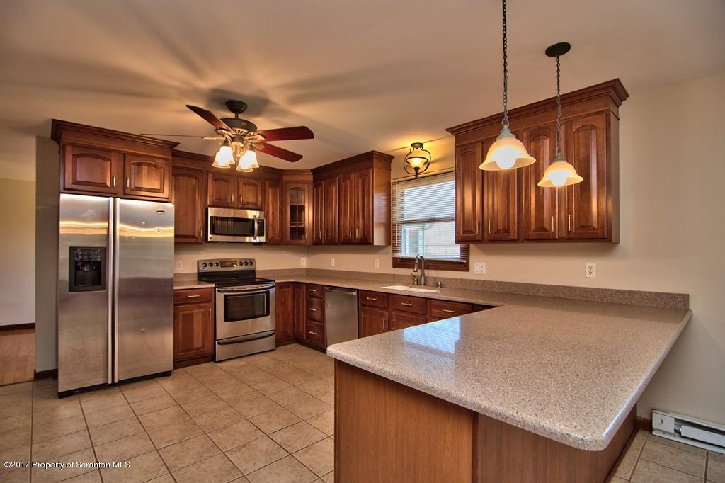 43 Hildebrandt Road Dallas, PA 18612 - Photo 11 of 54 a kitchen with stainless steel appliances granite countertop a sink a stove and a refrigerator