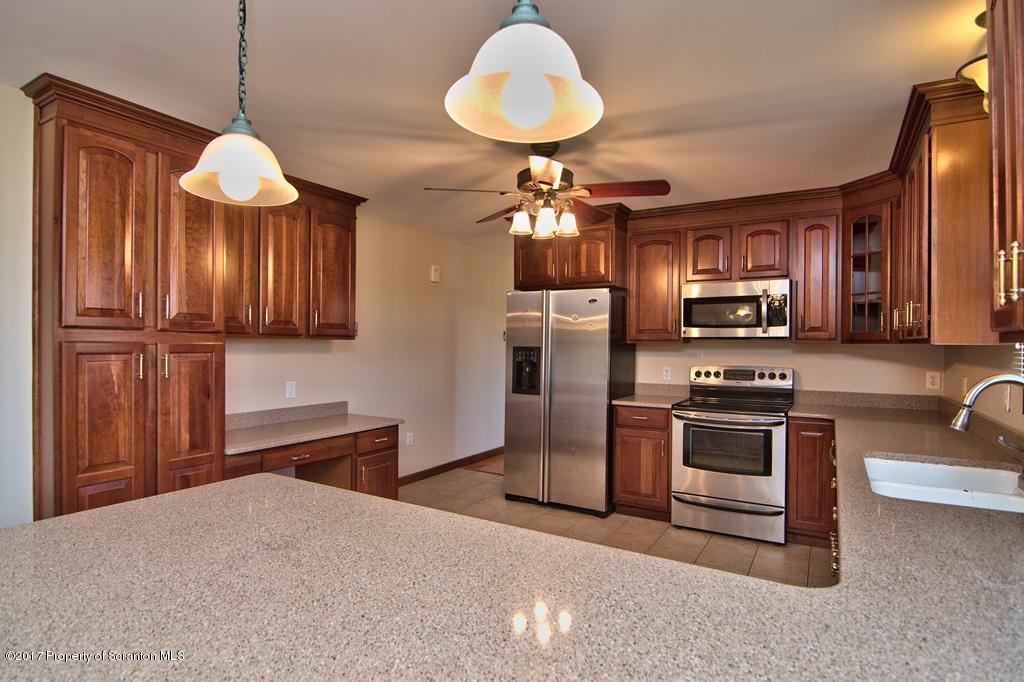 43 Hildebrandt Road Dallas, PA 18612 - Photo 12 of 54 a kitchen with stainless steel appliances granite countertop a stove refrigerator and microwave
