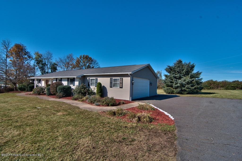 43 Hildebrandt Road Dallas, PA 18612 - Photo 2 of 54 a front view of a house with a yard and garage