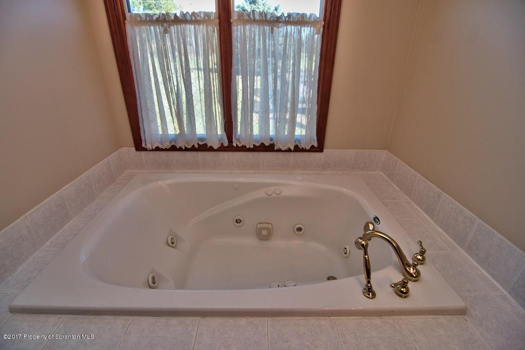 43 Hildebrandt Road Dallas, PA 18612 - Photo 29 of 54 a bathroom with a tub and a shower