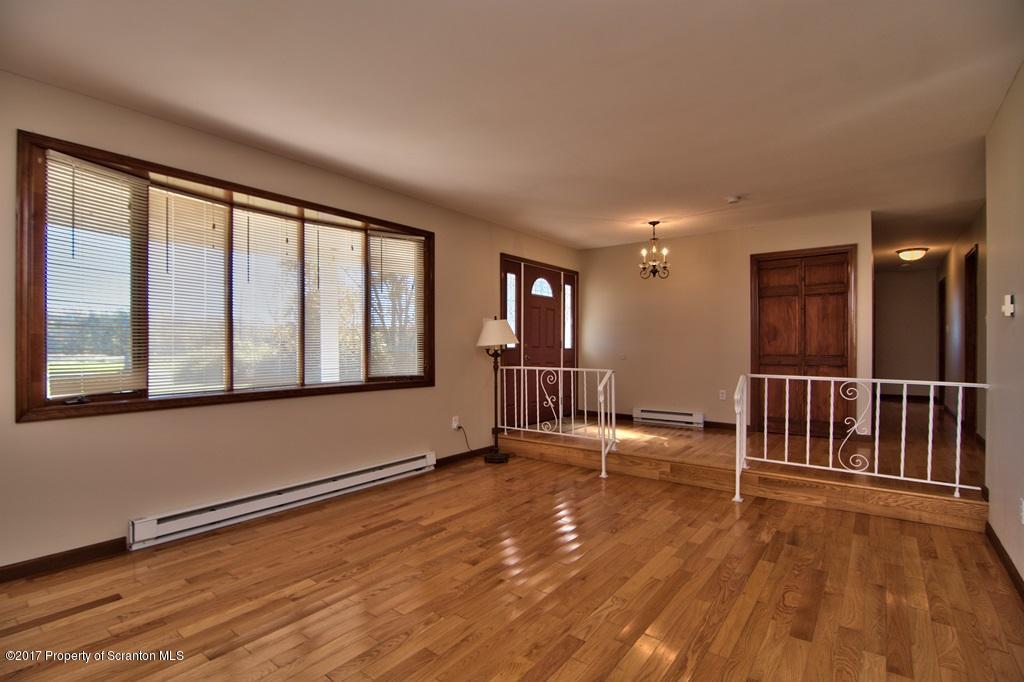 43 Hildebrandt Road Dallas, PA 18612 - Photo 5 of 54 a view of an empty room with wooden floor and a window