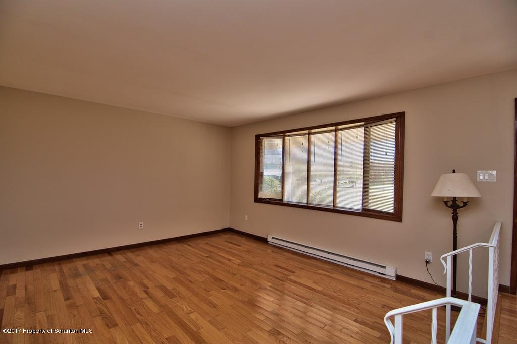 43 Hildebrandt Road Dallas, PA 18612 - Photo 7 of 54 a view of an empty room with wooden floor and a window