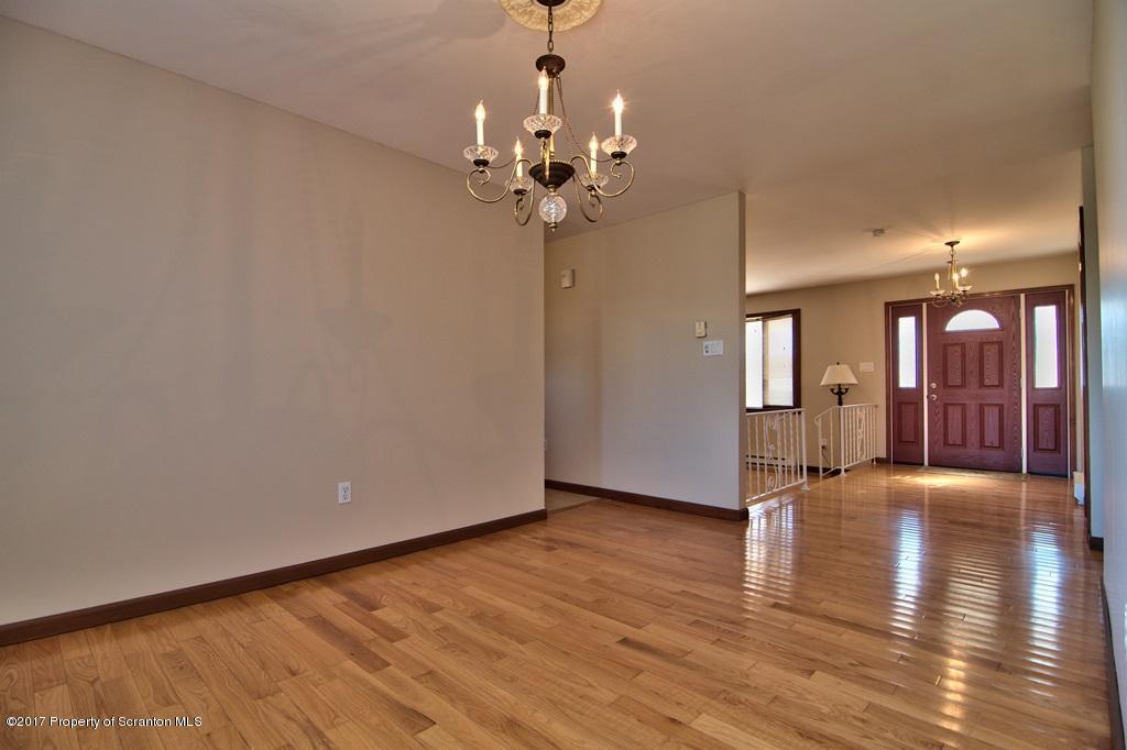43 Hildebrandt Road Dallas, PA 18612 - Photo 8 of 54 a view of an empty room with chandelier and wooden floor