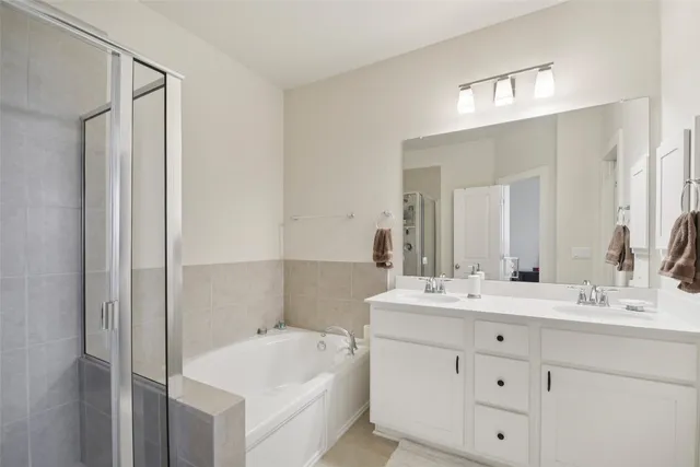 a bathroom with a tub sink and mirror