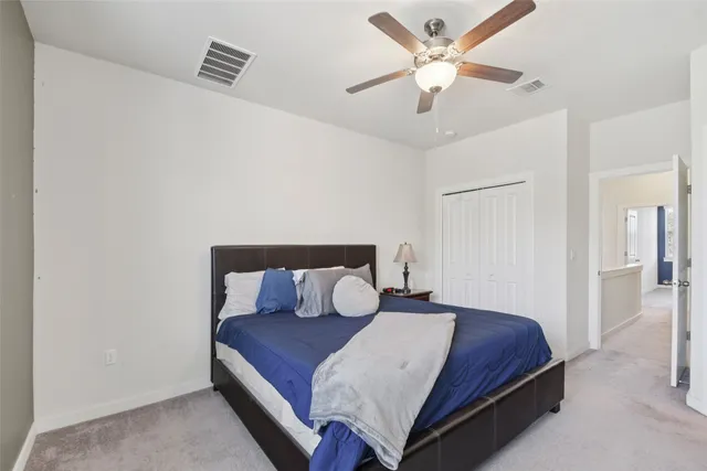 a bedroom with a bed and ceiling fan