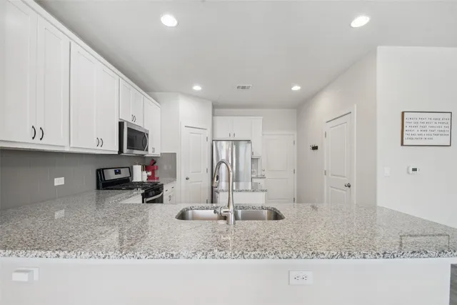 a kitchen with refrigerator and microwave