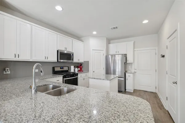 a kitchen with refrigerator and microwave