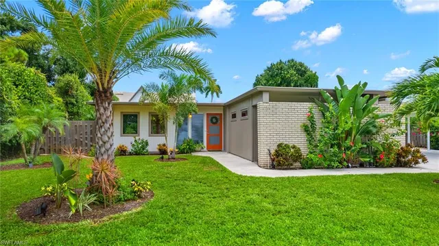 a front view of a house with a yard and porch