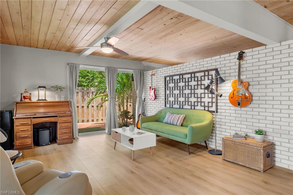 1599 Grove Avenue Fort Myers, FL 33901 - Photo 12 of 25 a living room with furniture a fireplace and a flat screen tv
