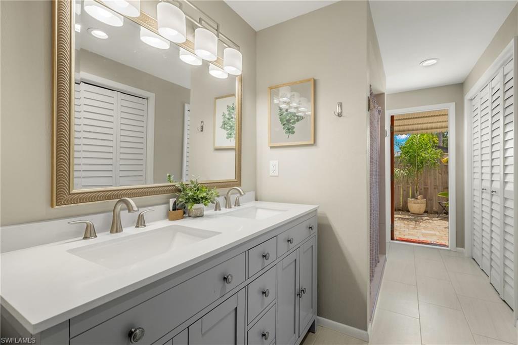 1599 Grove Avenue Fort Myers, FL 33901 - Photo 14 of 25 a bathroom with a sink and a mirror