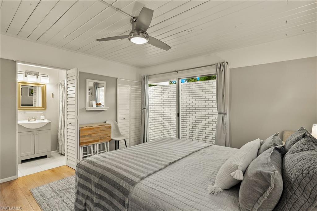 1599 Grove Avenue Fort Myers, FL 33901 - Photo 16 of 25 a bedroom with a bed and a chandelier