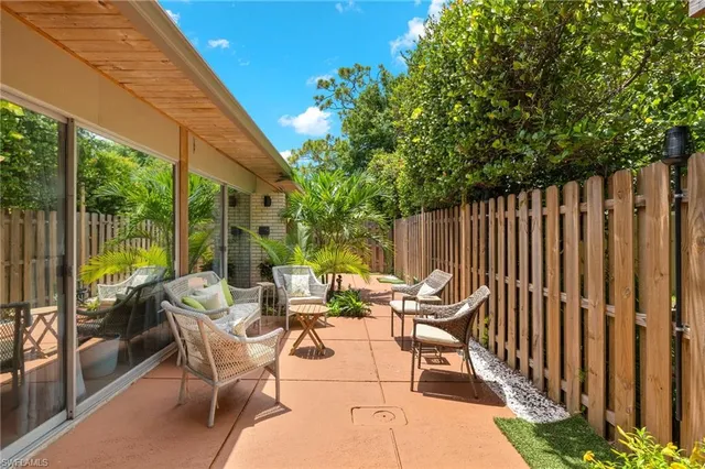 a view of a patio with a table chairs and a patio