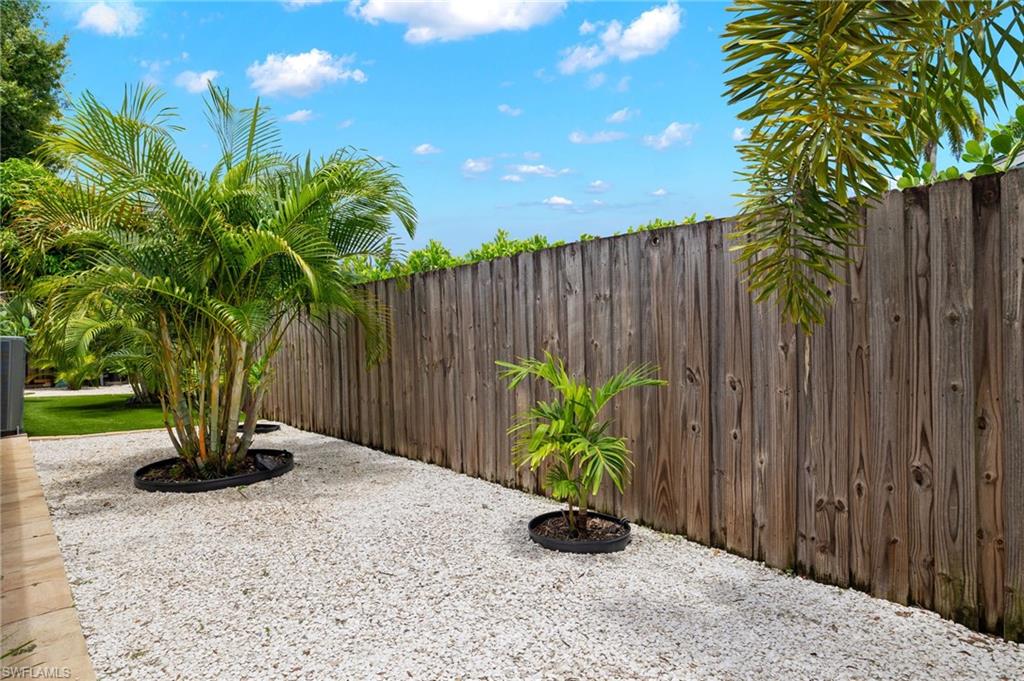 1599 Grove Avenue Fort Myers, FL 33901 - Photo 24 of 25 a view of a backyard with potted plants and wooden fence