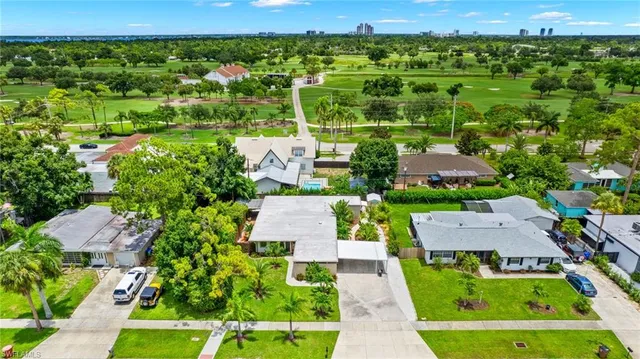 an aerial view of residential houses with outdoor space and street view
