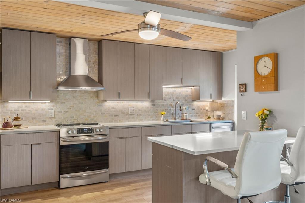 1599 Grove Avenue Fort Myers, FL 33901 - Photo 5 of 25 a kitchen with a stove a sink and a refrigerator