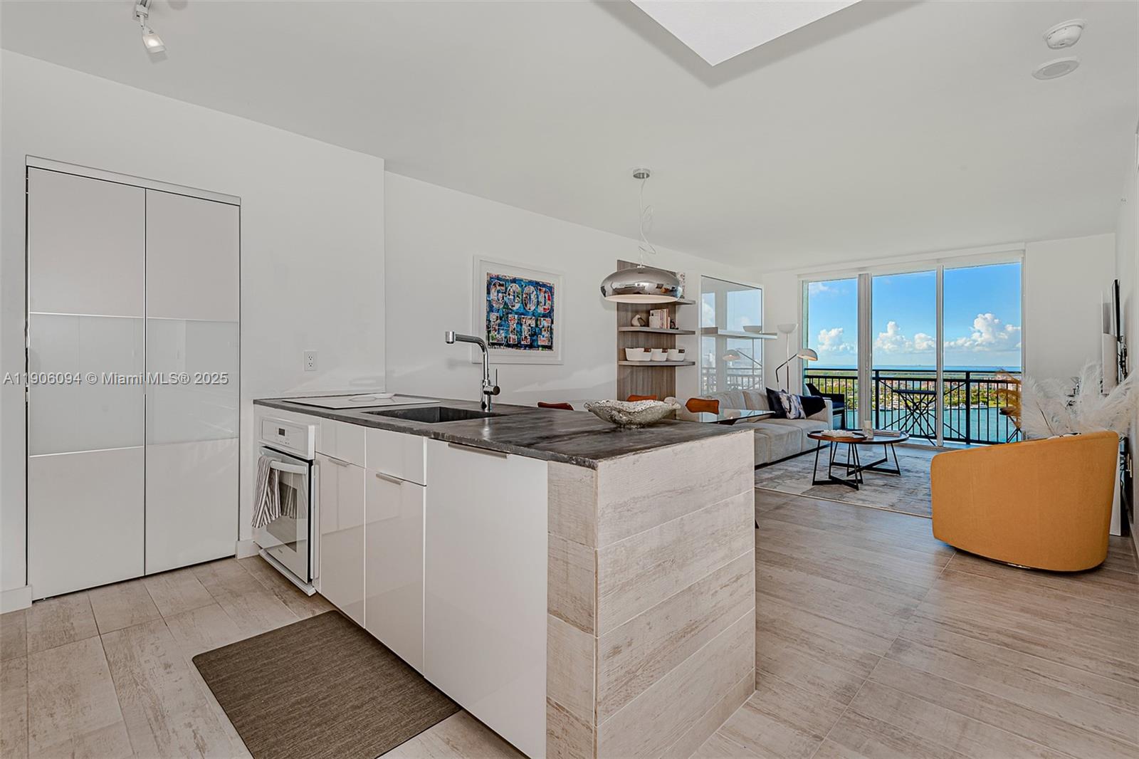 90 Alton Road, Unit 2506 Miami Beach, FL 33139 - Photo 11 of 22 a kitchen with stainless steel appliances granite countertop a sink and a stove top oven