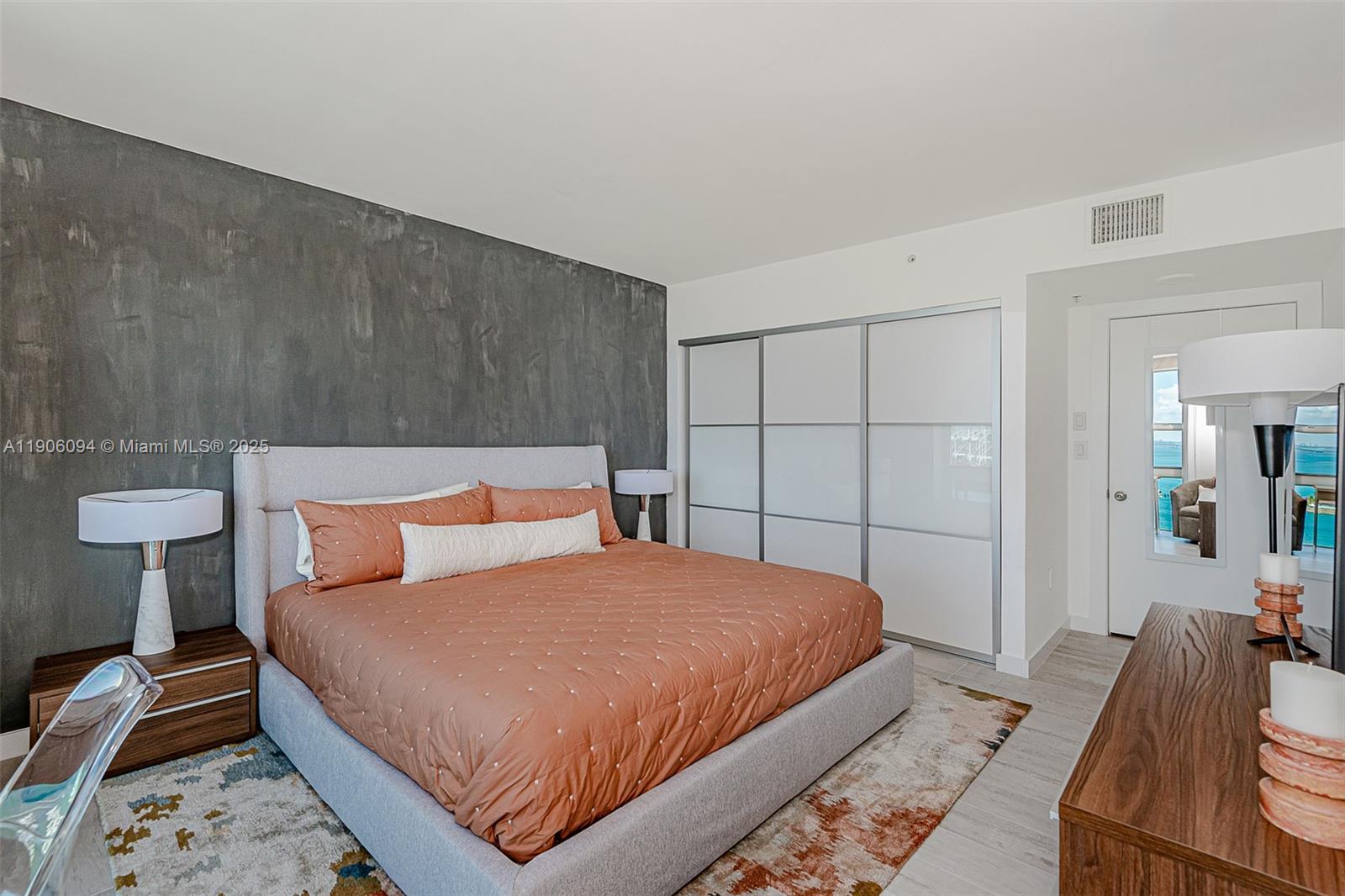 90 Alton Road, Unit 2506 Miami Beach, FL 33139 - Photo 17 of 22 a bedroom with a bed and wooden floor