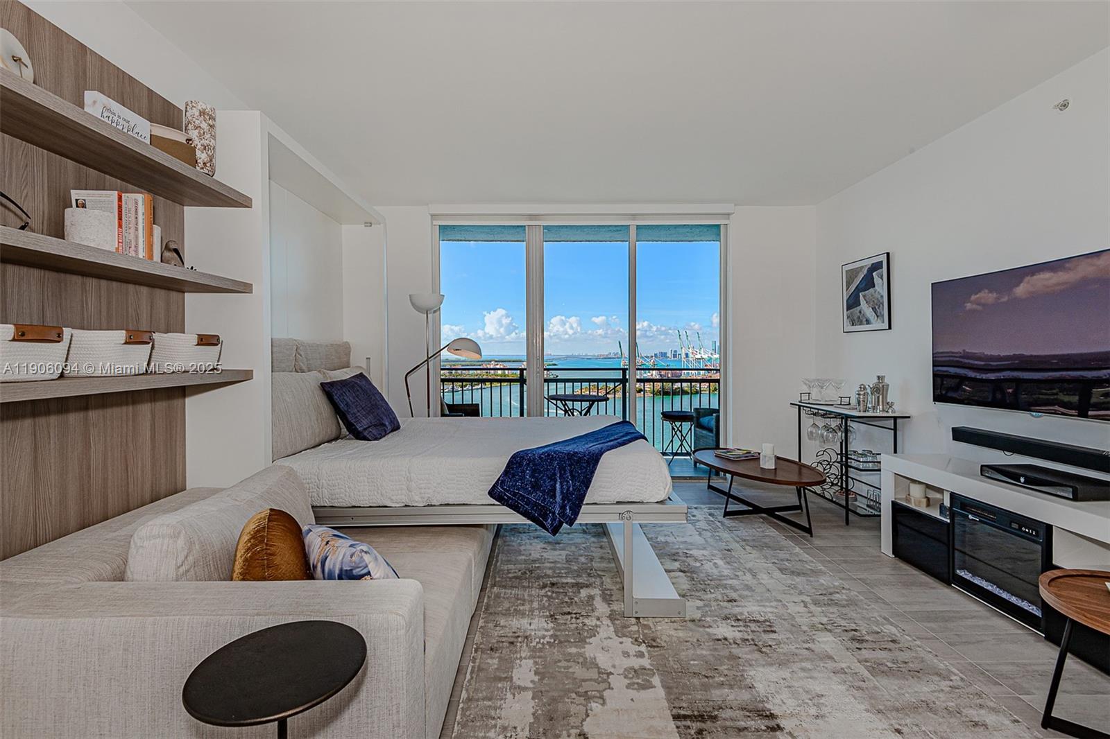 90 Alton Road, Unit 2506 Miami Beach, FL 33139 - Photo 4 of 22 a living room with furniture and a flat screen tv