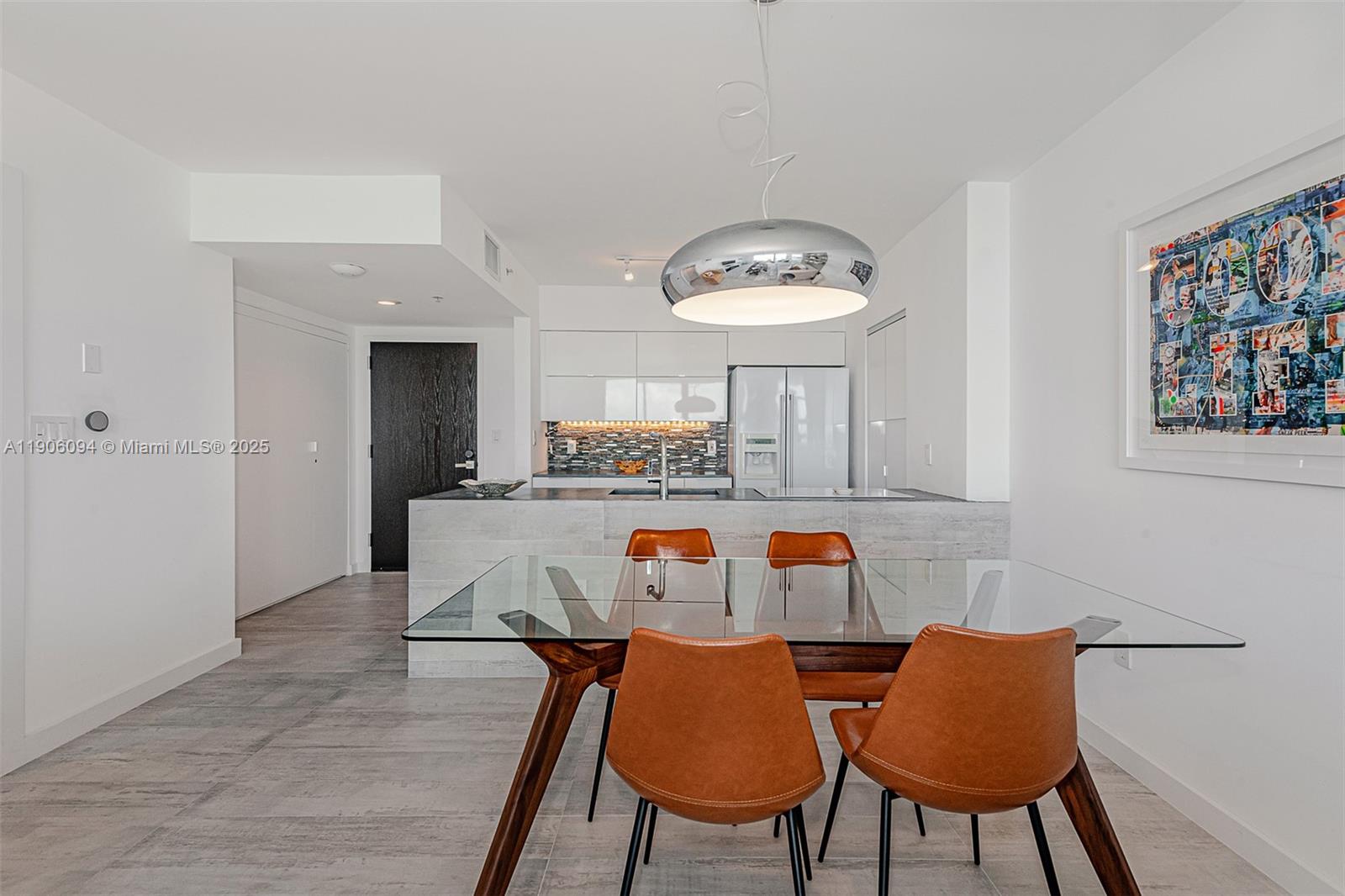 90 Alton Road, Unit 2506 Miami Beach, FL 33139 - Photo 9 of 22 a view of kitchen with dining area and chandelier