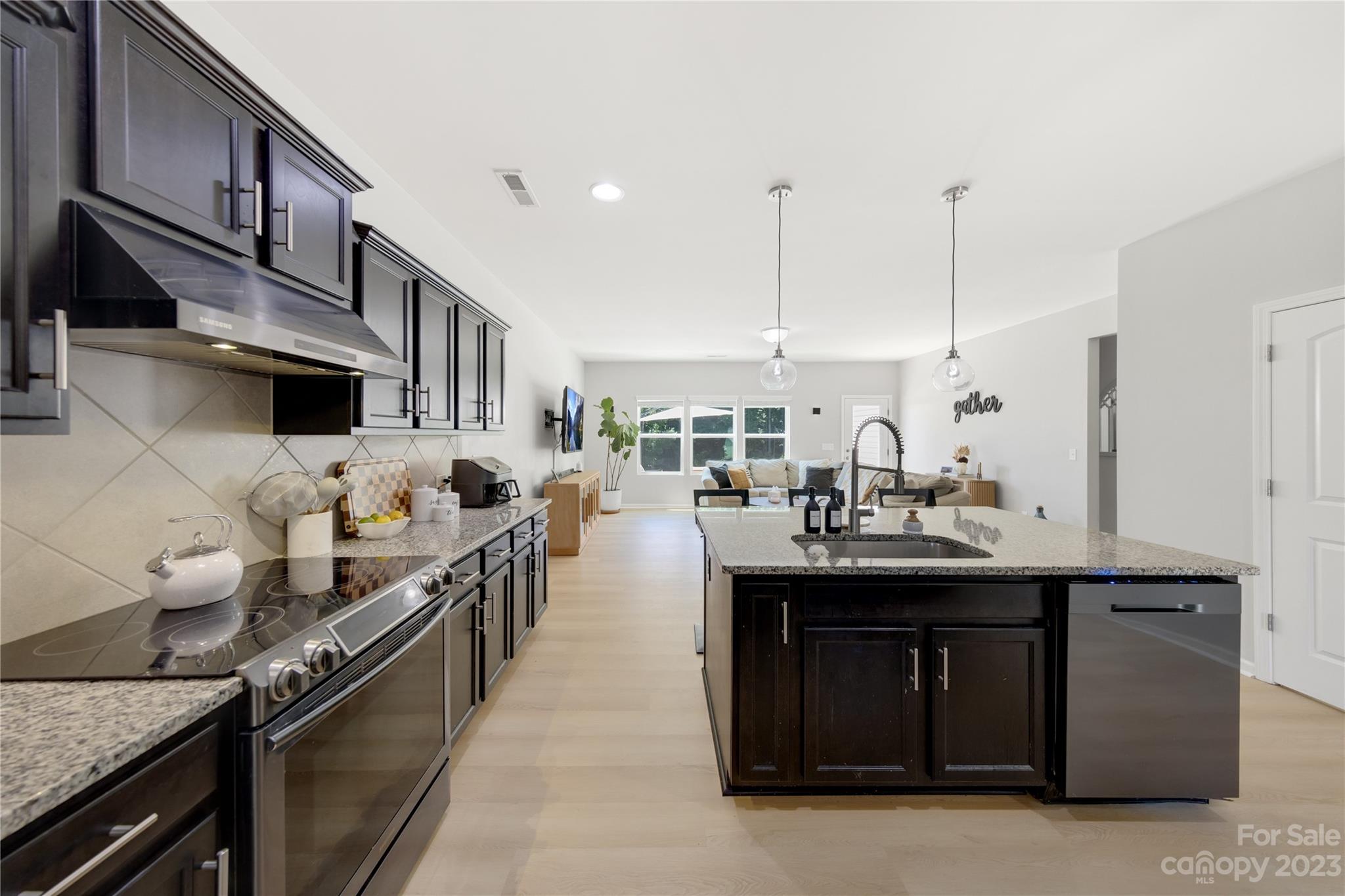 360 Wyndham Forest Circle Midland, NC 28107 - Photo 13 of 40 a kitchen with stainless steel appliances granite countertop a sink and a stove