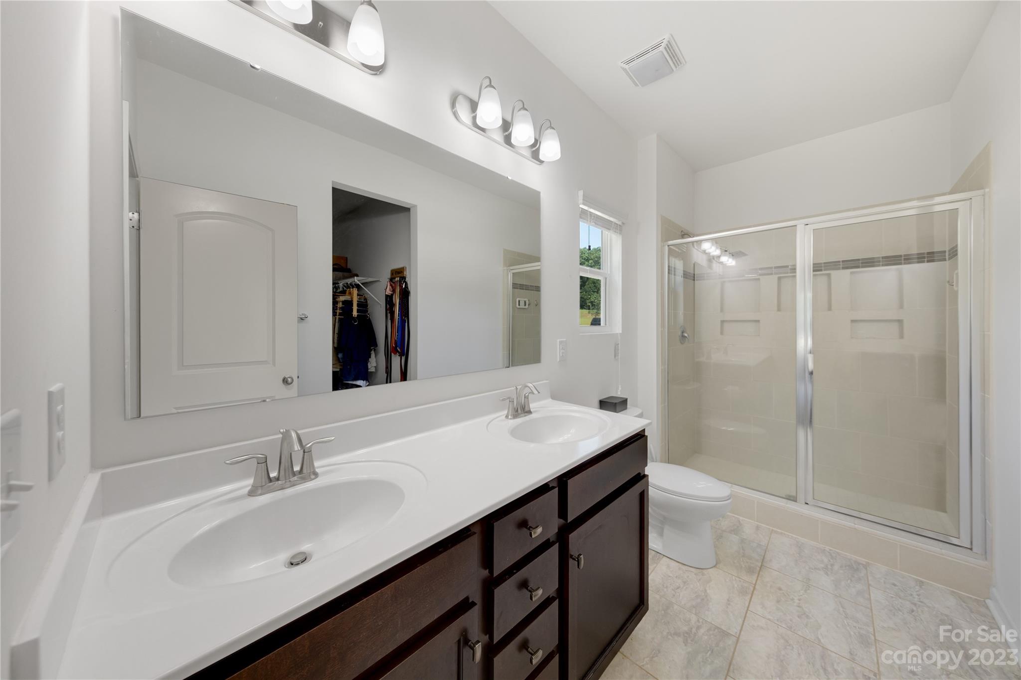 360 Wyndham Forest Circle Midland, NC 28107 - Photo 22 of 40 a bathroom with a sink double vanity granite tub shower and a mirror