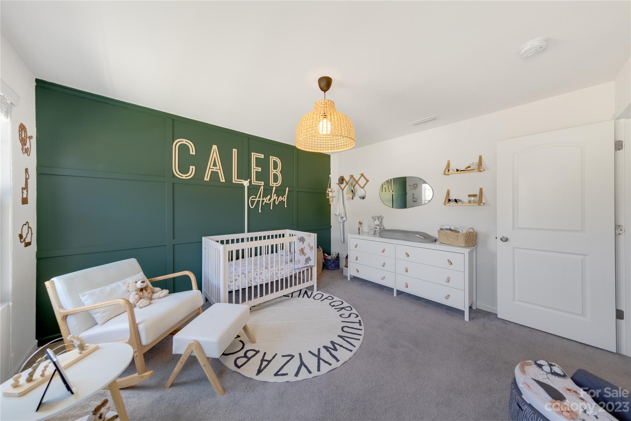 360 Wyndham Forest Circle Midland, NC 28107 - Photo 24 of 40 a bedroom with a bed and a chandelier