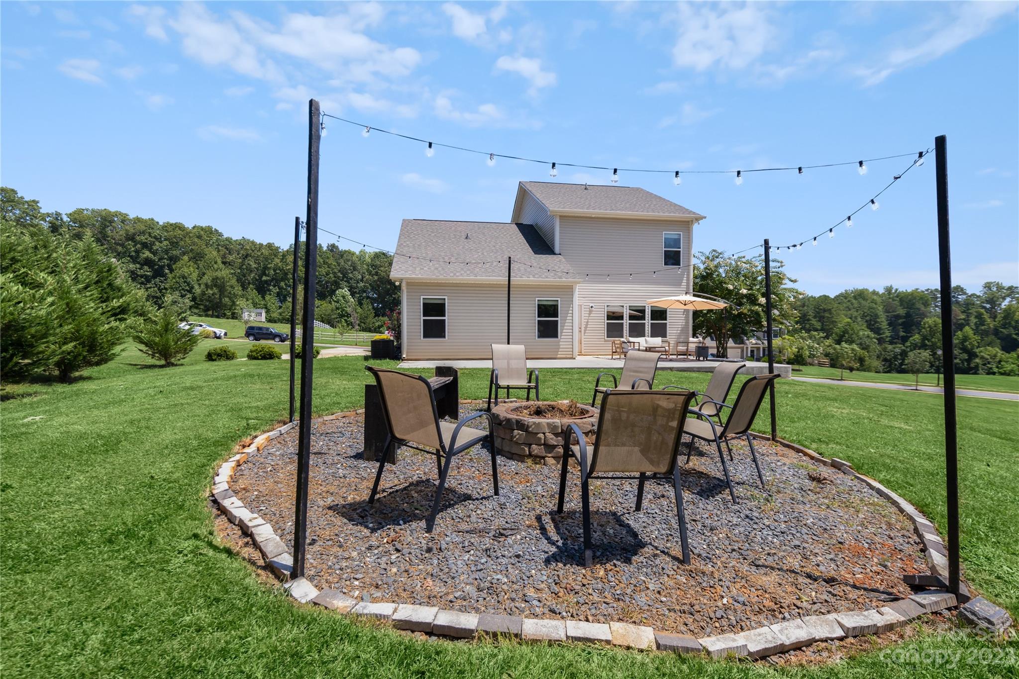 360 Wyndham Forest Circle Midland, NC 28107 - Photo 33 of 40 a view of a house with backyard sitting area and garden