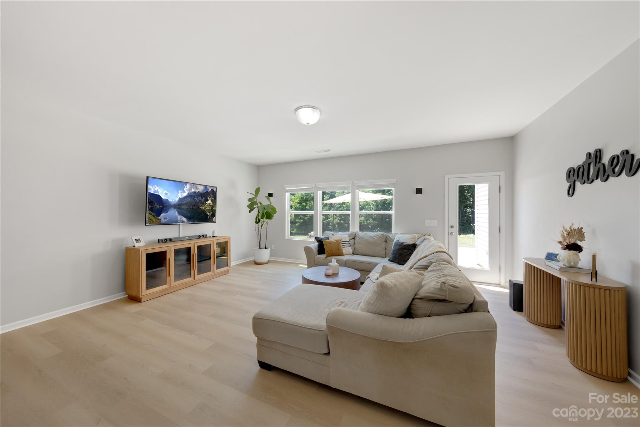 360 Wyndham Forest Circle Midland, NC 28107 - Photo 8 of 40 a living room with furniture flat screen tv and a fireplace