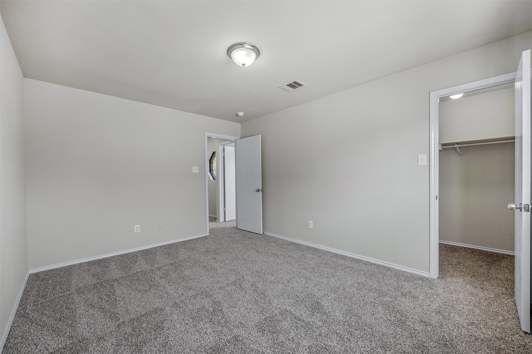 7541 Redrick Drive Austin, TX 78747 - Photo 34 of 40 Unfurnished bedroom with a spacious closet, visible vents, baseboards, carpet, and a closet