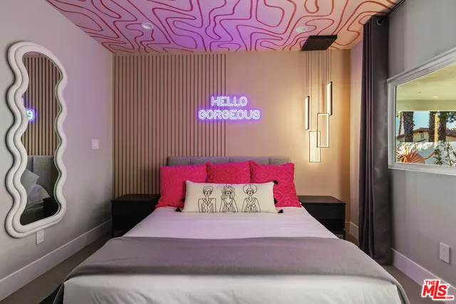 a bedroom with a large bed and a large window