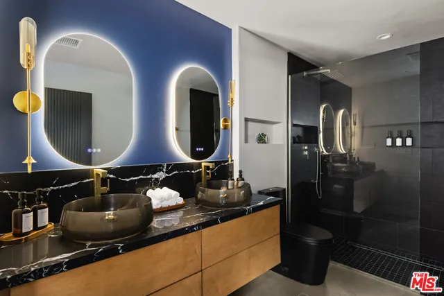 a bedroom with a bed and a painting on the wall