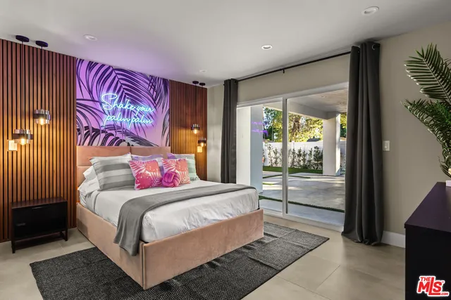 a bedroom with a large bed and a large window