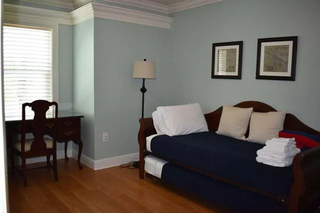 a living room with furniture lamp and window