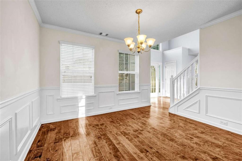 1903 Cobblestone Court Conyers, GA 30012 - Photo 12 of 30 a view of a room with wooden floor and chandelier