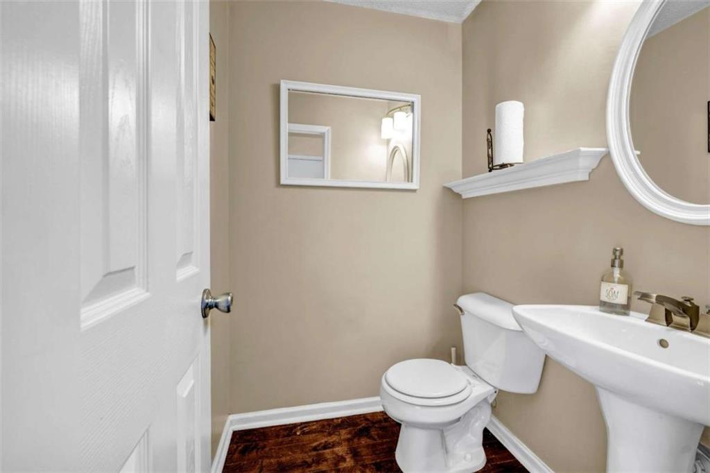 1903 Cobblestone Court Conyers, GA 30012 - Photo 13 of 30 a white toilet sitting next to a bathroom sink