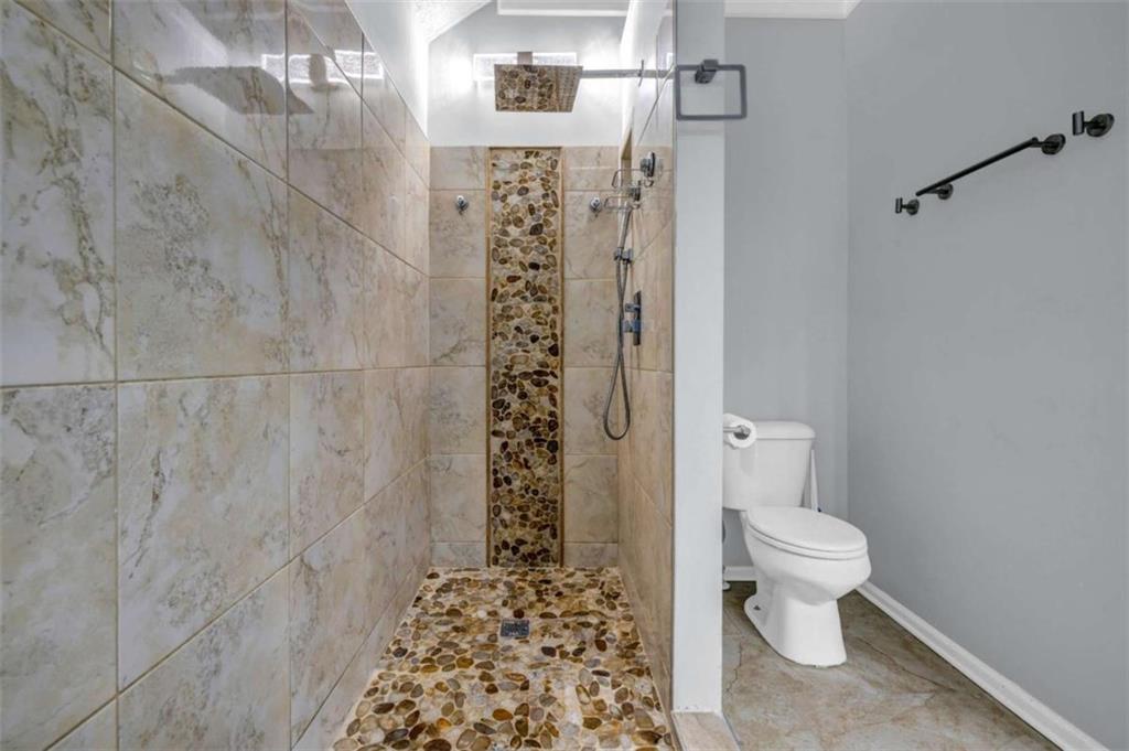 1903 Cobblestone Court Conyers, GA 30012 - Photo 18 of 30 a bathroom with a toilet and a shower