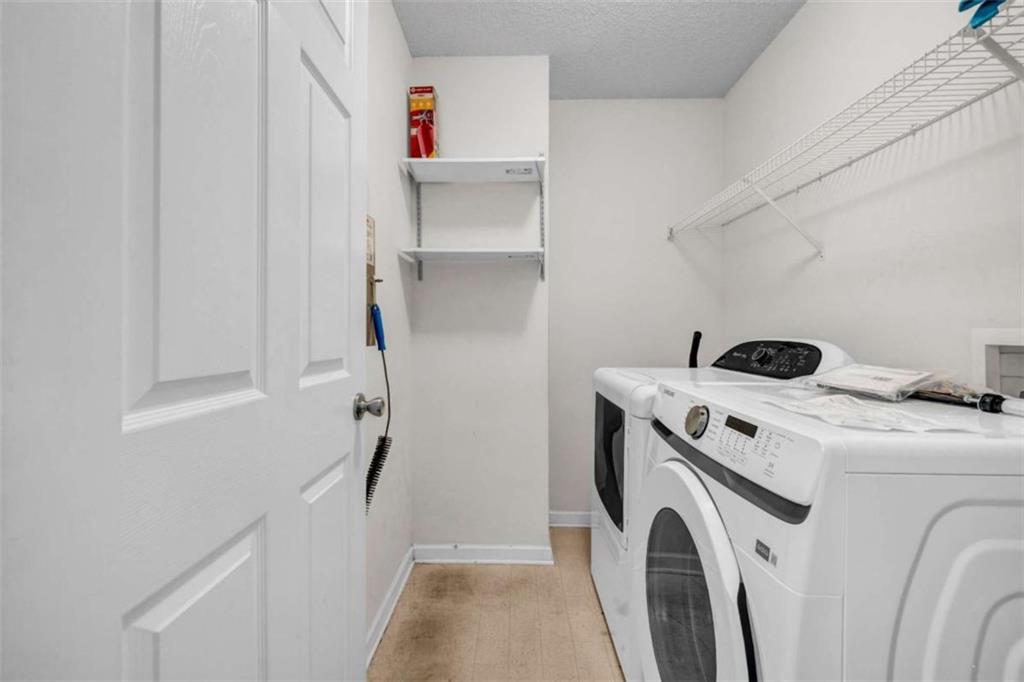 1903 Cobblestone Court Conyers, GA 30012 - Photo 21 of 30 a utility room with dryer and washer