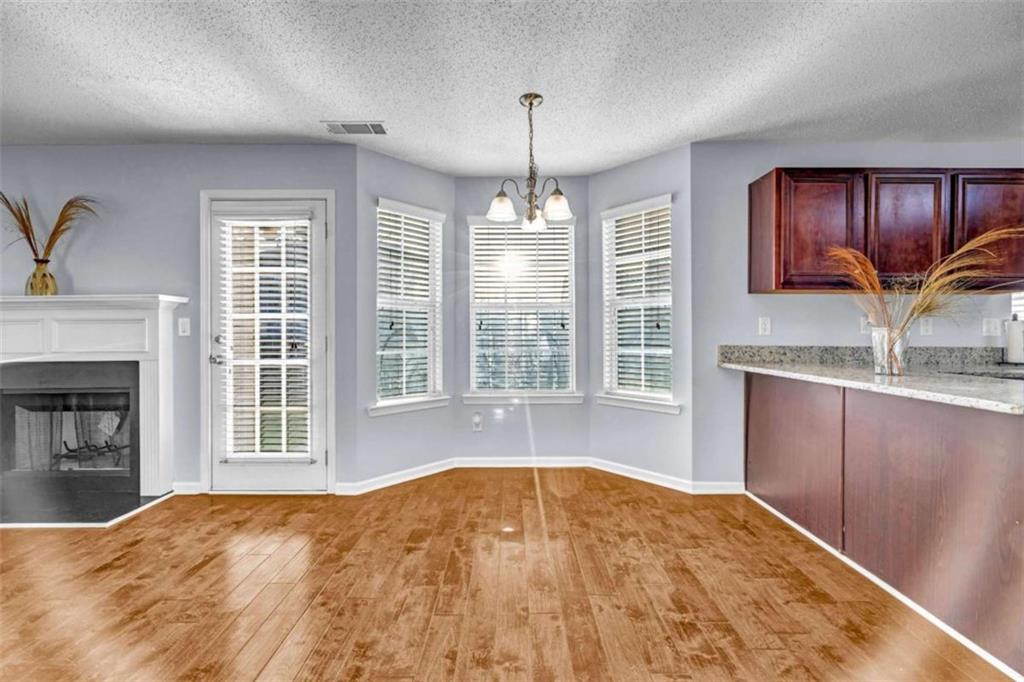1903 Cobblestone Court Conyers, GA 30012 - Photo 5 of 30 a view of a kitchen with a sink and a fireplace