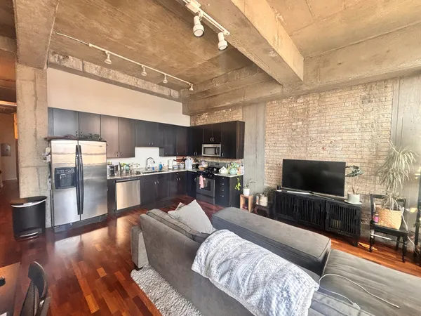 a bed sitting in a spacious bedroom next to a window